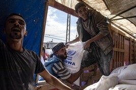 UNRWA agency hands out bags of flour to Palestinians in Khan Younis