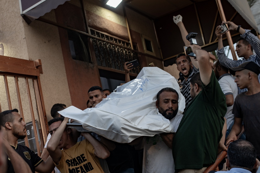 Palestinian families gather next to bodies at Nasser Hospital in Gaza