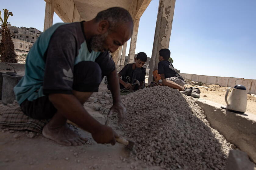 Palestinians make graves from the rubble of Gaza's destroyed homes