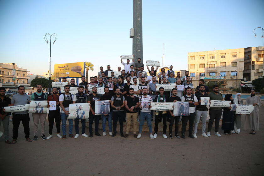 Syrian journalists protest after a colleague was arrested in northern Syria