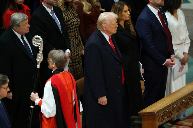 Reverend Mariann Edgar Budde (front) passes US President Donald Trump (C) during the National Prayer - RIPRODUZIONE RISERVATA